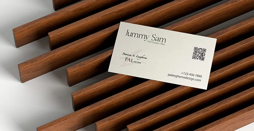 PAL Design business card on dark wooden slats