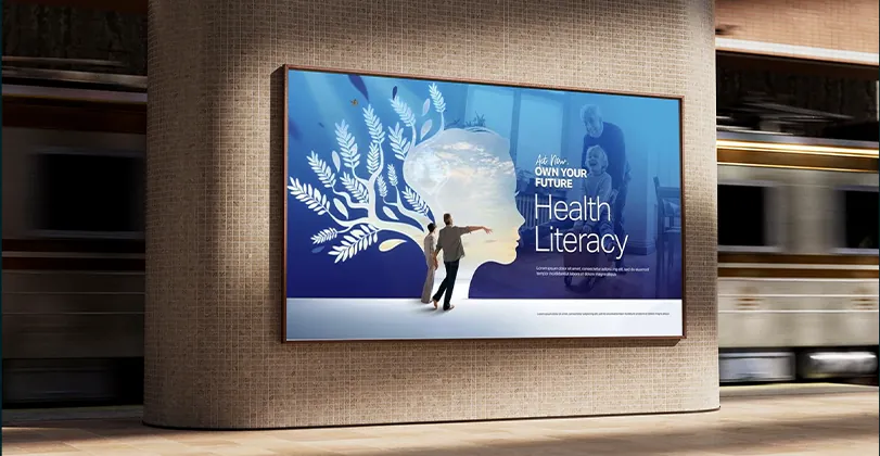 SelfCheck Health Literacy billboard on a wall beside a passing train