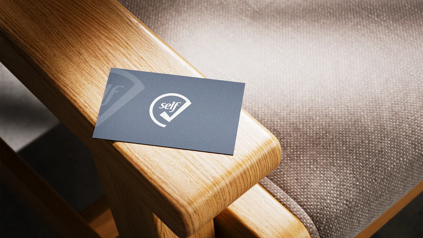 SelfCheck business card on a wooden bench